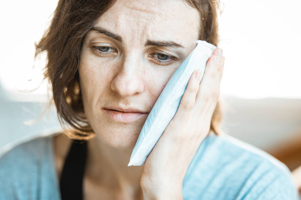woman with ice pack on jaw